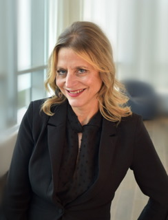 A headshot of Catherine Ashcraft smiling at the camera