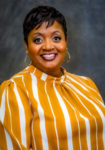 A headshot of Andrea Bowens-Jones smiling at the camera