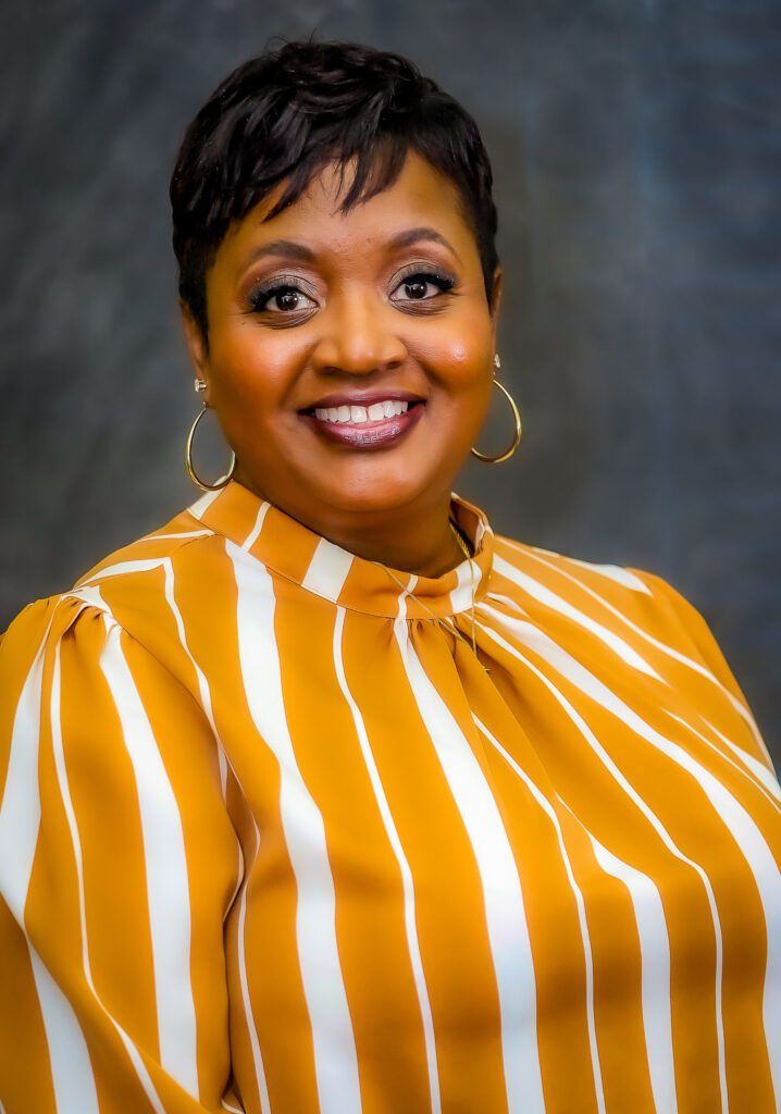 A headshot of Andrea Bowens-Jones smiling at the camera