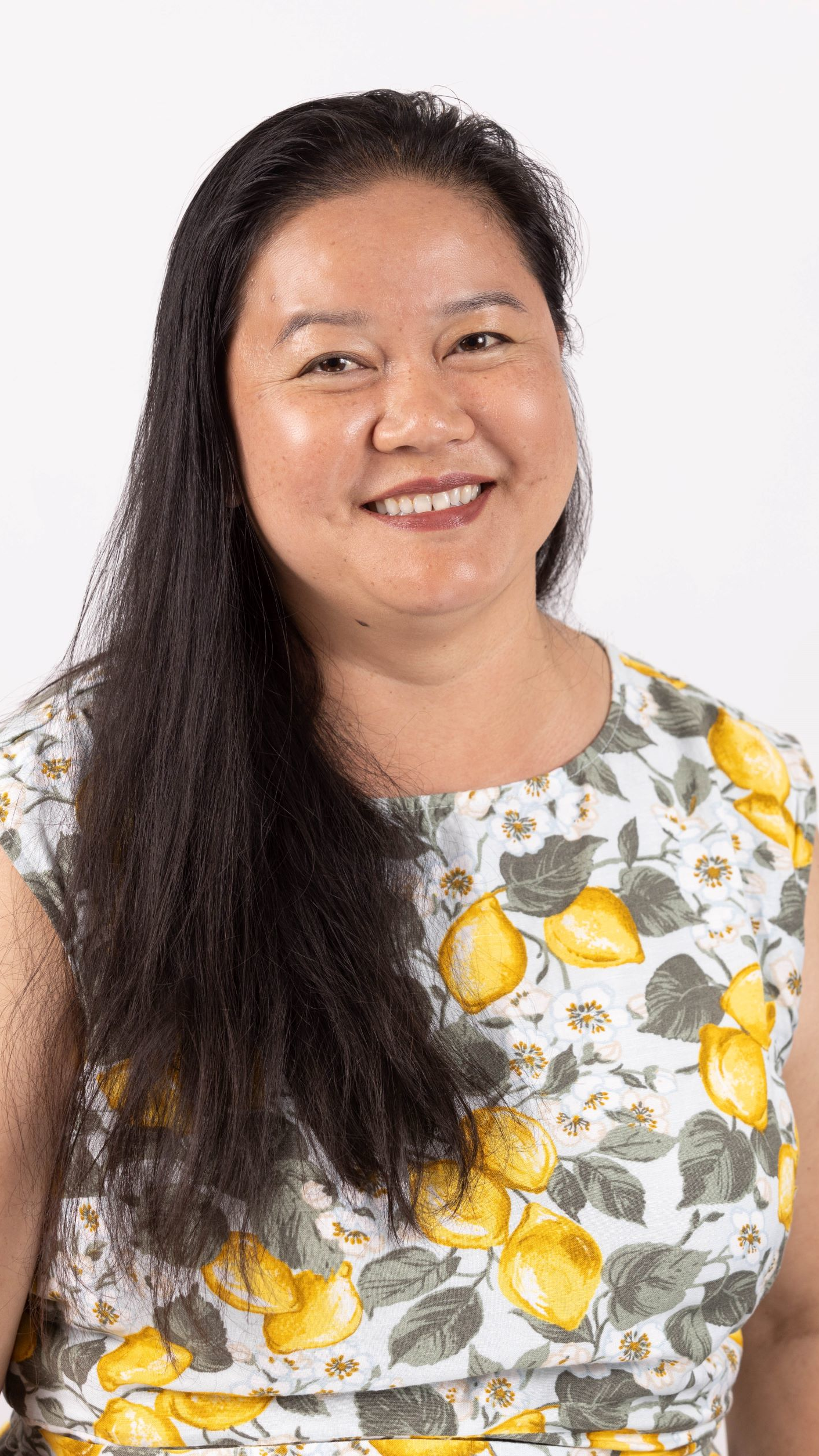 Color photo of Khamphet Pease, a 2023 National Educator Award recipient, smiling toward the viewer.