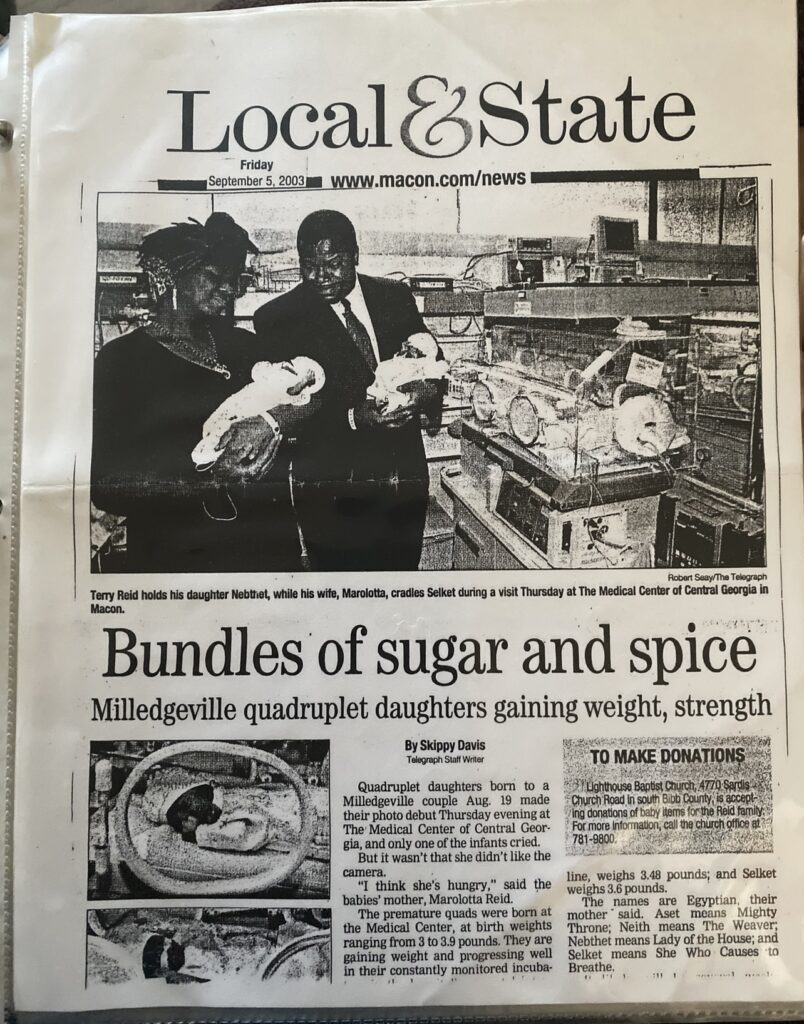 Black and white newspaper clipping of Neith and her sisters being born. Text reads: “Bundles of sugar and spice: Midgeville Quadruplet daughters gaining weight, strength | September 5, 2003”