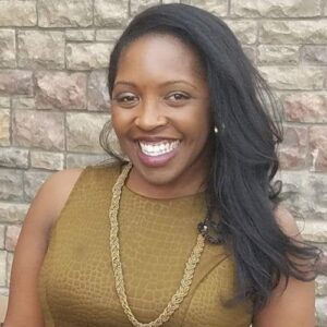 A headshot of Renise Walker smiling at the camera