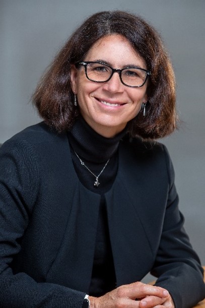 A headshot of Katherine Wetmur smiling at the camera