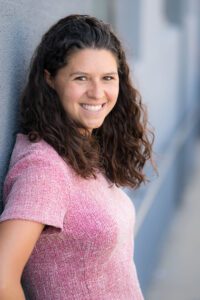 A headshot of Katherine Novinski smiling at the camera