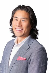 A headshot of pat Yongpradit smiling at the camera