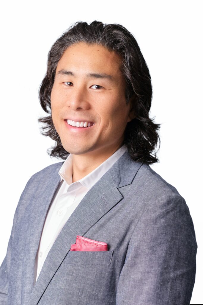 A headshot of pat Yongpradit smiling at the camera